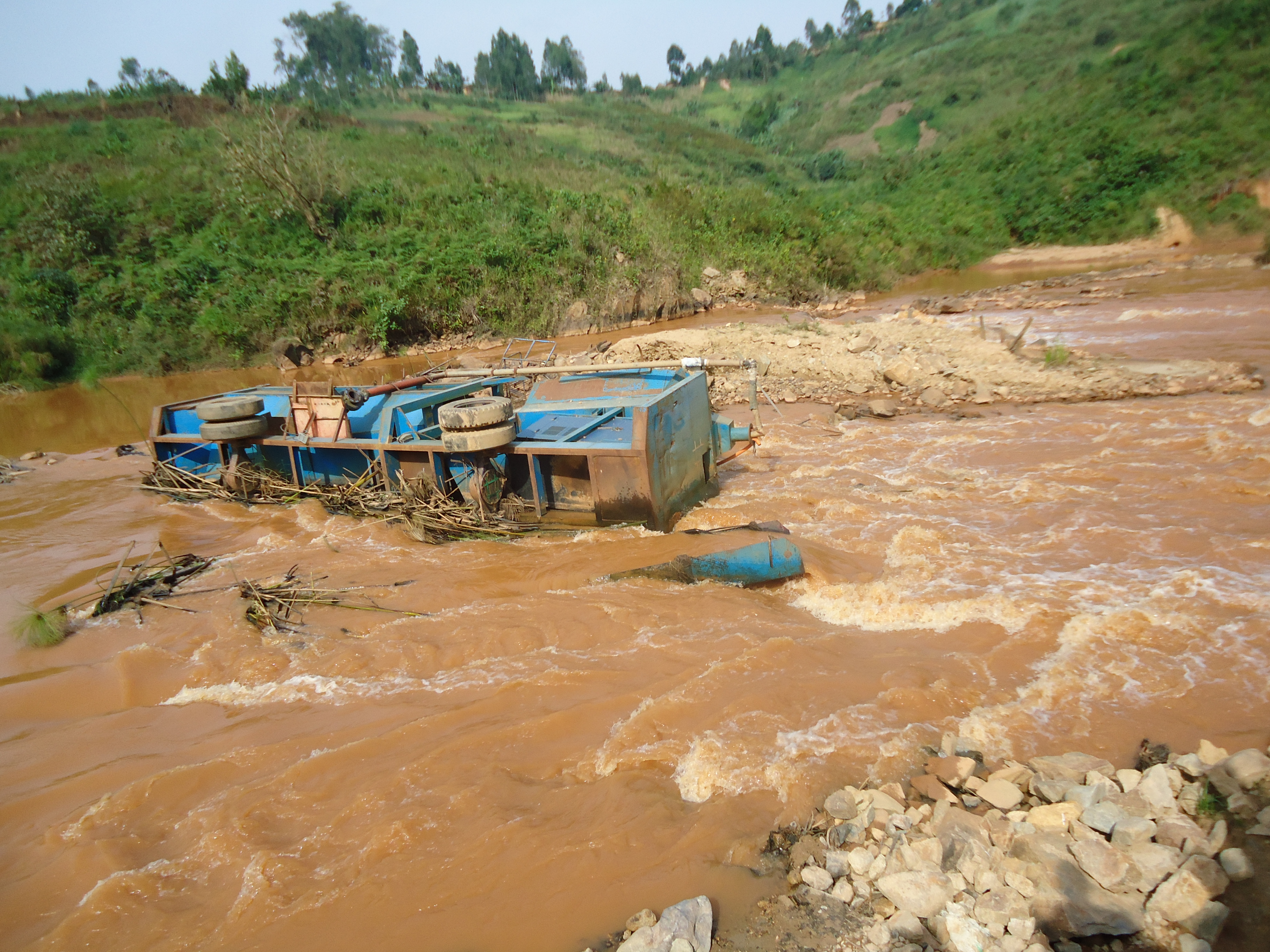 Korean Dave's Gold processing machine lying on its side in The Nizi River