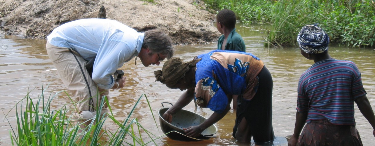 Woman gold panning in a diamond washing pit, Sierra Leone 2005.